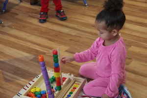 toddler using building blocks at Kidz Camp Montessori - Plano, TX