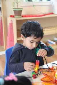 boy using sensory toy at Kidz Camp Montessori School - Plano, TX