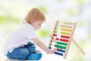 boy counting numbers on abacus in plano, tx