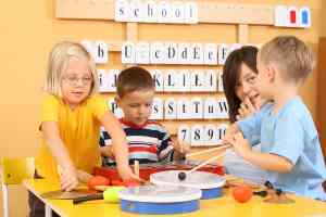 teacher guiding kids in music instruction